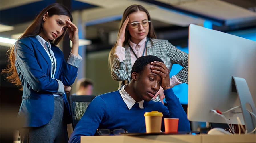 Frustrated office workers dealing with IT problems
